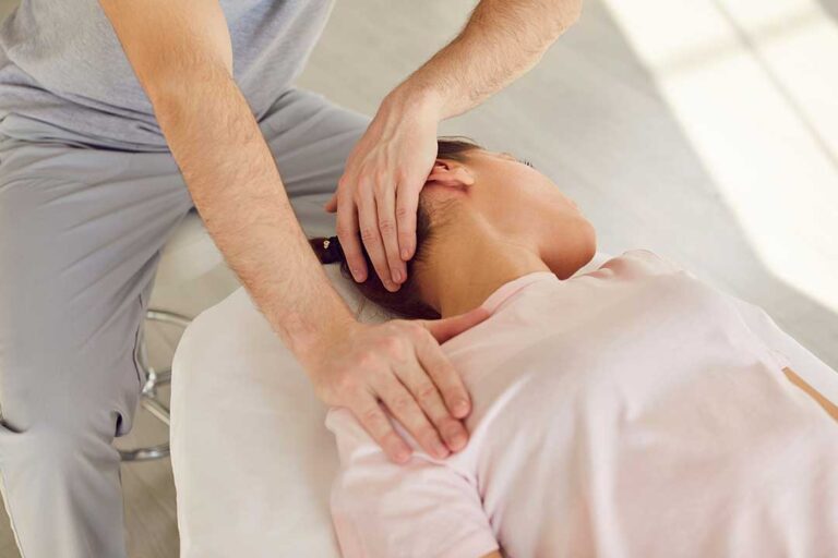 A chiropractor discusses spine health with an adult and child during a routine checkup in a bright, welcoming office.